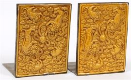 Lot#1144, CHINESE BRASS AND CERAMIC BOOKENDS, C.1910-1920, PAIR, H 5"An orange-yellow glaze covers Foo dogs playing with a ball on each panel, etched flowering plant at the opposite side.  Impressed 'Made in China'. From the collection of Mrs. G. G. Scranton, international traveler from the late 1800's to the mid twentieth century. Friend and patron of Mrs. Dagny Carter, a notable scholar, influenced this collection.