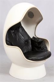 Lot#1183, MID-CENTURY MODERN MOLDED PLASTIC EGG CHAIR, H 59", L 34"A white molded plastic egg chair with two speakers, audio inputs and black cushioned seat and back.