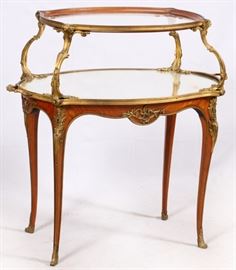 Lot#1351, FRENCH LOUIS XV BRONZE MOUNTED MARQUETRY TEA TABLE, H 38", W 38" A French tiered and mirrored table, a mirrored main top with acanthus leaf mounts and subtle cabriole leg.  Measures H.38 1/2" x 38" x 21 1/2".