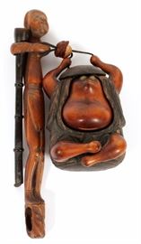 Lot#1386, JAPANESE WOOD FIGURAL PIPE CASE (KISERU) AND TOBACCO BOX (TONKOTSU), L 8 1/4"A whimsical wood tobacco box (tonkotsu), H.4 1/2" x 3", fitted with a mask bead, and stretched figural pipe and pipe case (kiseru), L.8 1/4". From the collection of Mrs. G. G. Scranton, international traveler from the late 1800's to the mid twentieth century. Friend and patron of Mrs. Dagny Carter, a notable scholar, influenced this collection.