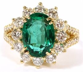 Lot#2088, 5.26CT EMERALD AND 2.00CT DIAMOND RING, GIA, SIZE 8. An oval cut 5.26ct natural emerald surrounded by 2.00cts round diamonds, set in 18kt yellow gold.  The diamonds have a G color and Vs-2 clarity grading.  GIA report #5182154739.  Weighs 13.1 grams.