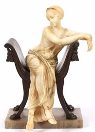 Lot#2136, ART DECO ALABASTER SCULPTURE, H 12.5", L 8", D 8", SEMI-NUDE FEMALE. Depicting a semi-nude female, carved in alabaster, seated in a Savonarola style bench which has paw feet. Mounted on an onyx base.  Illegibly signed and marked Firenze and Made In Italy.