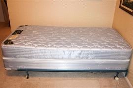 Two Twin Mattresses, Boxsprings, and Frames: One Diamond Mattress Co. Spinal Pedic Twin Mattress, Boxspring, and Frame: Good condition, except for small tear in mattress, and torn corners on boxspring. One Executive Osteo-pedic Supreme Puff Quilted Twin Mattress, Boxspring, and Frame: Very good condition, except for small stain on mattress.