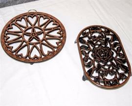 Eight Piece Trivet Set: Set includes six vintage Wilton cast iron trivets and two large decorative cast iron trivets