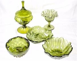 Five Piece Vintage Green Pressed Glassware: one 10" H x 5.5" W covered candy dish, one 3" H x 7" W dish w/ floral design, one 7" dish w/ berry design, one 5" fluted candy dish, one 3" H x 5.5" W dish w/ metal base