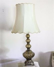 Glass and Brass Table Lamp: Smoky brown glass w/ brass footed base. 6" L x 8" W x 39" H w/ 18" W x 18" H lampshade. Inner lampshade lining torn