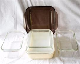 Four Piece Pyrex Cookware Set: one brown square 2 qt. baking dish, two rectangular 1.5 qt. bread pans, one vintage rectangular 2 qt. baking dish w/ lid