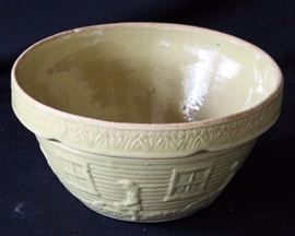 Vintage Yellow Ware McCoy 10" Bowl: Bottom of bowl is marked Ransbottom Pottery, USA  #166-10. Design is of a little girl in a garden, watering flowers with a can under a window. The pattern repeats six times. Under the rim, the bowl has indentations for easy handling. Made in early 1900's.