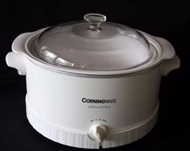Three Piece Corningware Cookware Set: One 5 L Corningware Electrics slow cooker, one 1.5 qt. round baking dish w/ lid, one 2.6 L oval baking dish w/ lid. Plastic trim on bottom rim of slow cooker is split.