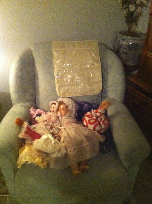 upholstered chair and dolls