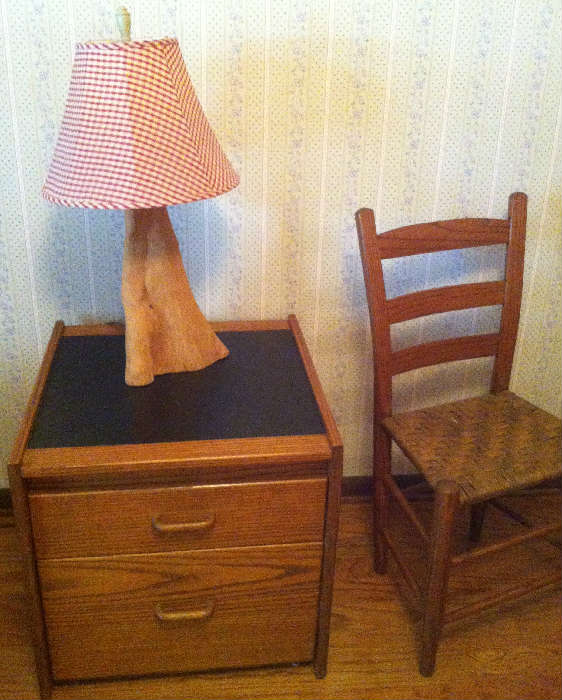 night stand, lamp, ladder back chair