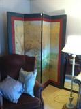 Painted screen, chocolate wing chair, floor lamp