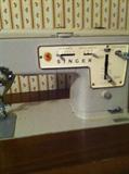 Singer sewing machine in cabinet