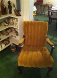 Queen Anne classic chair with bookshelf of items from Kenya, France, Italy, Germany, etc.
