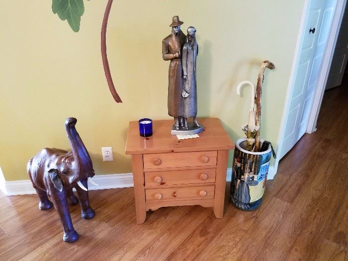 The statue is by David Fisher from 1987, umbrella stand, and an elephant