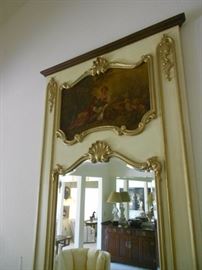 Oil painting within frame of mirror.  "Trumeau mirror".  A type of wall mirror originally manufactured in France in the later 18th century. It takes its name from the French word Trumeau, which designates the space between windows. Such a mirror, usually rectangular, could also hang above an overmantel.