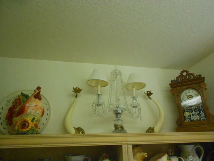 Hauy Pouigo candle holders on top shelf.