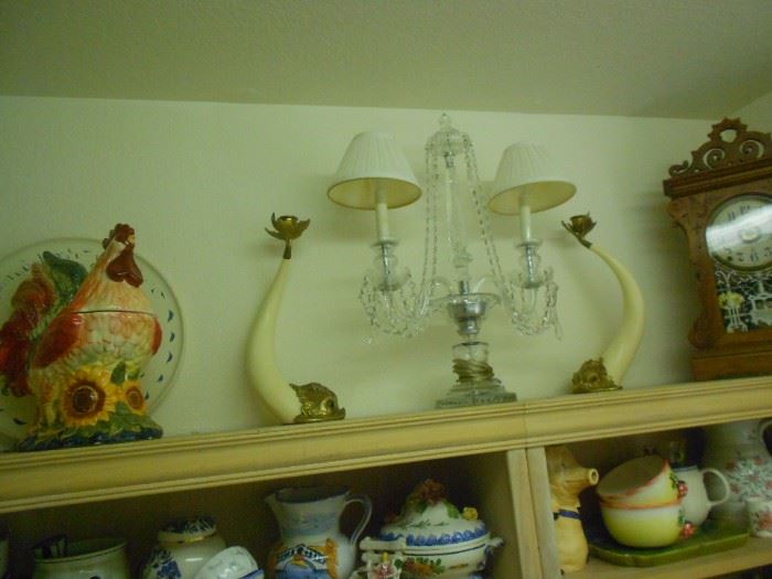 Hauy Pouigo candle holders on top shelf.