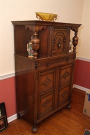 Antique carved china cabinet with unusual angled display areas on top portion.  Dish and steins to be sold separately.
