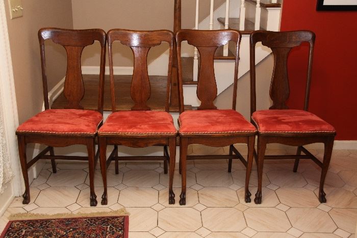 Four antique oak dining chairs with microfiber upholstered seats.