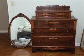 Sweet antiques dresser with leaf motif in contrasting wood.  Three large drawers and two small drawers which lock.  Matching mirror.
