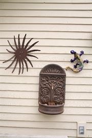 Outdoor decor items including a Mexican painted lizard.