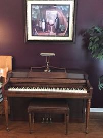 Piano and matching bench.  Bench is filled with sheet music.  There are also two cartons of sheet music.