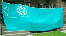 1972 Munich Street Banner flown during Olympics, special find brought home by Son in Army there. Dimensions 20' Wide x 7.5' Tall. All snap hooks top and bottom great shape sealed in plastic last 45 years.
