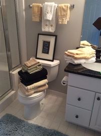 Assorted bath towels and rugs