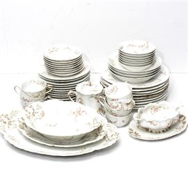 Antique Theodore Haviland Limoges "Norma" China Collection: An antique Theodore Haviland Limoges “Norma” pattern china collection. This antique china features gentle floral swags with gold accents on a white ground. In this collection are nine dinner plates, twelve bread plates with four soup bowls and seven fruit bowls with a singel teacup and eight saucers. In addition, this collection includes a gravy boat with plate, an 11.50" oblong serving dish, a 10.00" oblong vegetable plate, and a 15.50" oblong serving platter. Each of the fifty-two pieces in this collection are marked by the maker to the reverse.