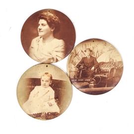 Antique Celluloid Tin Buttons: A collection of antique celluloid tin buttons. A portrait of a gentleman in a car is paired with the image of a post-Victorian lady and a child sitting patiently in this brief collection of celluloid images transferred onto tin buttons.