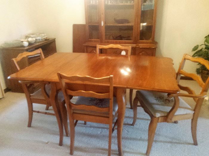 French Country drop leaf dining table w/4 chairs. Each chair has a handmade needlepoint seat.