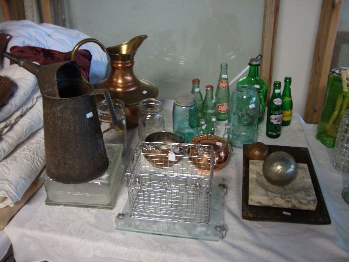 Galvanized water can, copper pitcher; vintage soda bottles