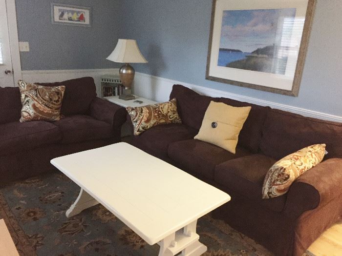 Comfy couch, love seat, coffee & occasional tables, book shelf, rug, & home decor!