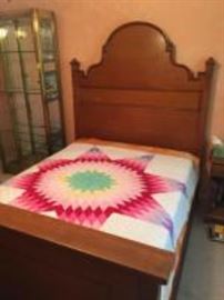 Antique double bed with linens
