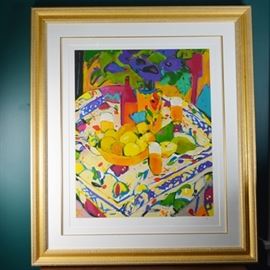 Manuel Anoro _Bodegon Con Mentel_ Limited Edition Serigraph: A limited edition serigraph titled Bodegon Con Mentel by Manuel Anoro (Spanish, b. 1945). This brightly colored still life depicts a bowl of oranges on a textile-covered table. This work reflects Anoro’s passion for color, his personal interpretation of beauty, and the strong colors and techniques of Fauvism. This art is marked artist proof, numbered 19/25, and pencil signed on lower right. It is presented in a gold tone textured frame under glass with a white mat, finished with a gold tone border. Framed by The Frame Center Gallery.