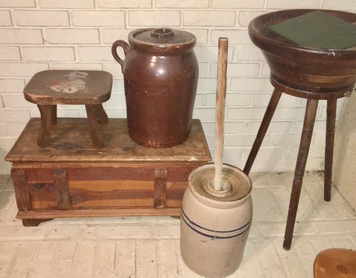 Two churn crocks (brown one is cracked; churn in foreground is in good condition), small cedar chest, wooden salad bowl on rotating stand