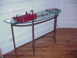 Glass top metal sofa table; costume jewelry; Dooney & Burke handbag