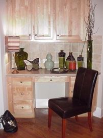Decorative vases, tiles, glass bottles, leather covered chair with wood legs
