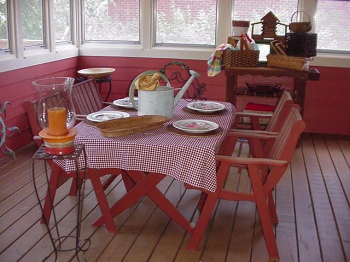 Teak table and four teak chairs for outdoor entertaining; galvanized watering can; decorative stands, candles, baskets, serving trays, and more