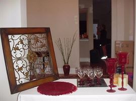 Framed ironwork; red placemats and candleholders, mirror plateau, red stem glassware