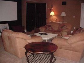 Wood and metal coffee table; leather sofa, loveseat and chair