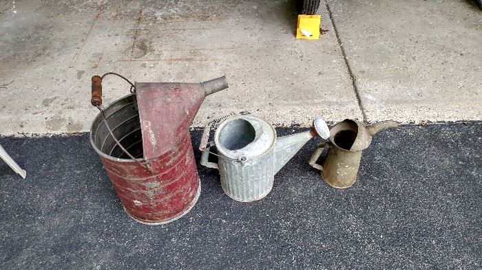 Early gas can, watering can, and oil can.