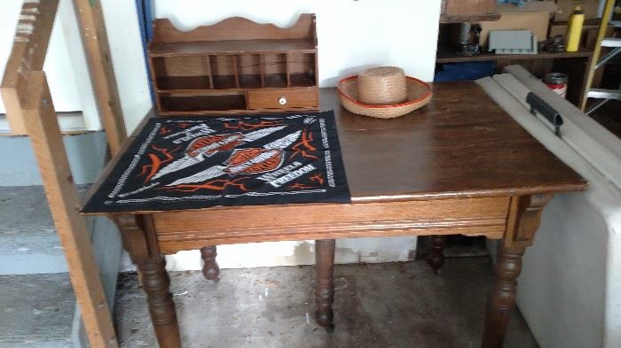 Oak 5 leg table, Harley Davidson scarf, straw hat, wooden slotted box.