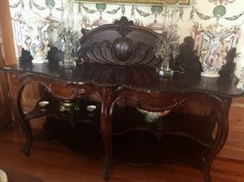 146 - Rare Mahogany Rococo sideboard with 2 shelves and bulls eye backsplash with plumb pudding finish, ca. 1860
