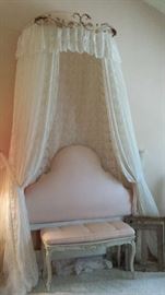 Pink upholstered headboard and bench with romantic lace and tulle part canopy