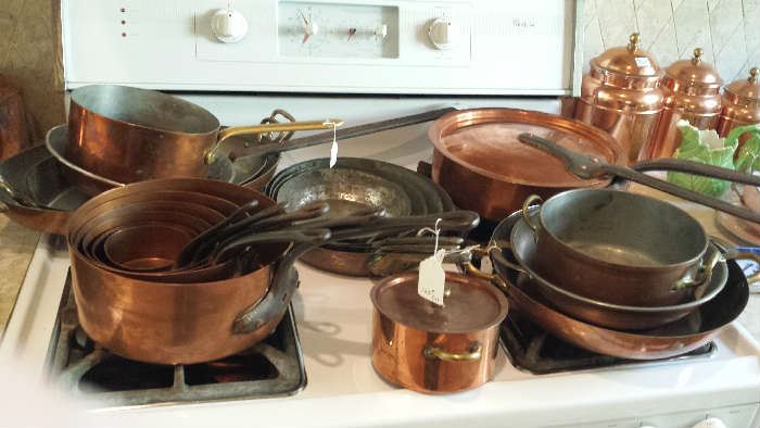 copper pots and pans, various ages and quality.