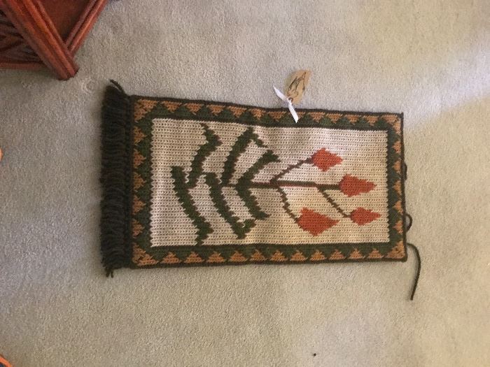 small woven floral throw or rug.