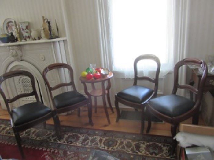Four chairs with slip seats, Round table with shelf has blown fruit and vegetables.  The Mantle shown upper left has Lenox plates ,vases and candlesticks. The rug is 14'6" x 8'6" made in Turkey.