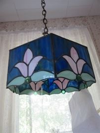 Mrs. Minard drew the pattern for this lamp and had it made from her pattern.  There are 3 lamps in the house made by this local artist. Two are in the sale. There is also 3 stained leaded glass pieces in the sale.